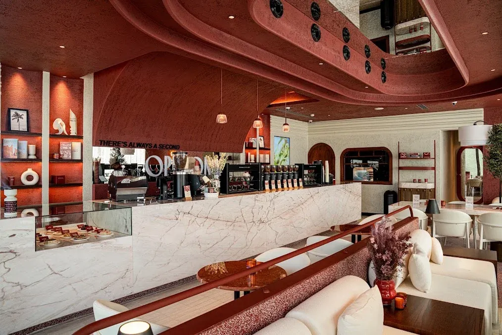 The OPINION interior with its sculpted burgundy ceiling and marble bar